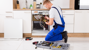 Technician repairing a household appliance in Roseville, CA, showcasing the benefits of professional appliance repair services over DIY fixes.